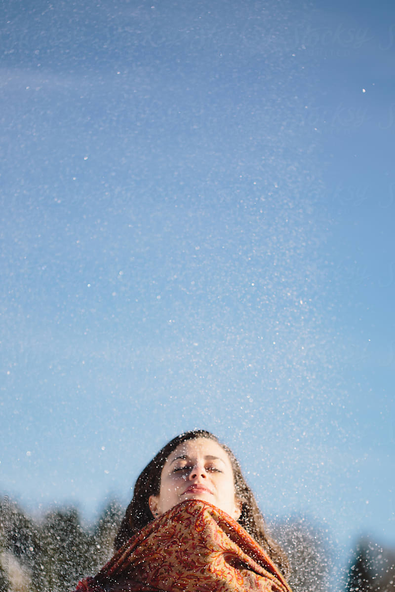 Brunette Woman Playing With Snow By Stocksy Contributor Michela