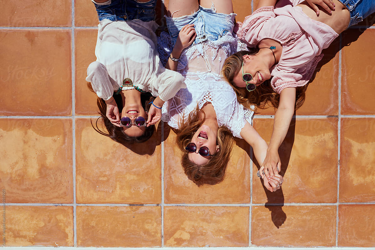 Cheerful Girls On Roof Floor In Sunlight Del Colaborador De Stocksy
