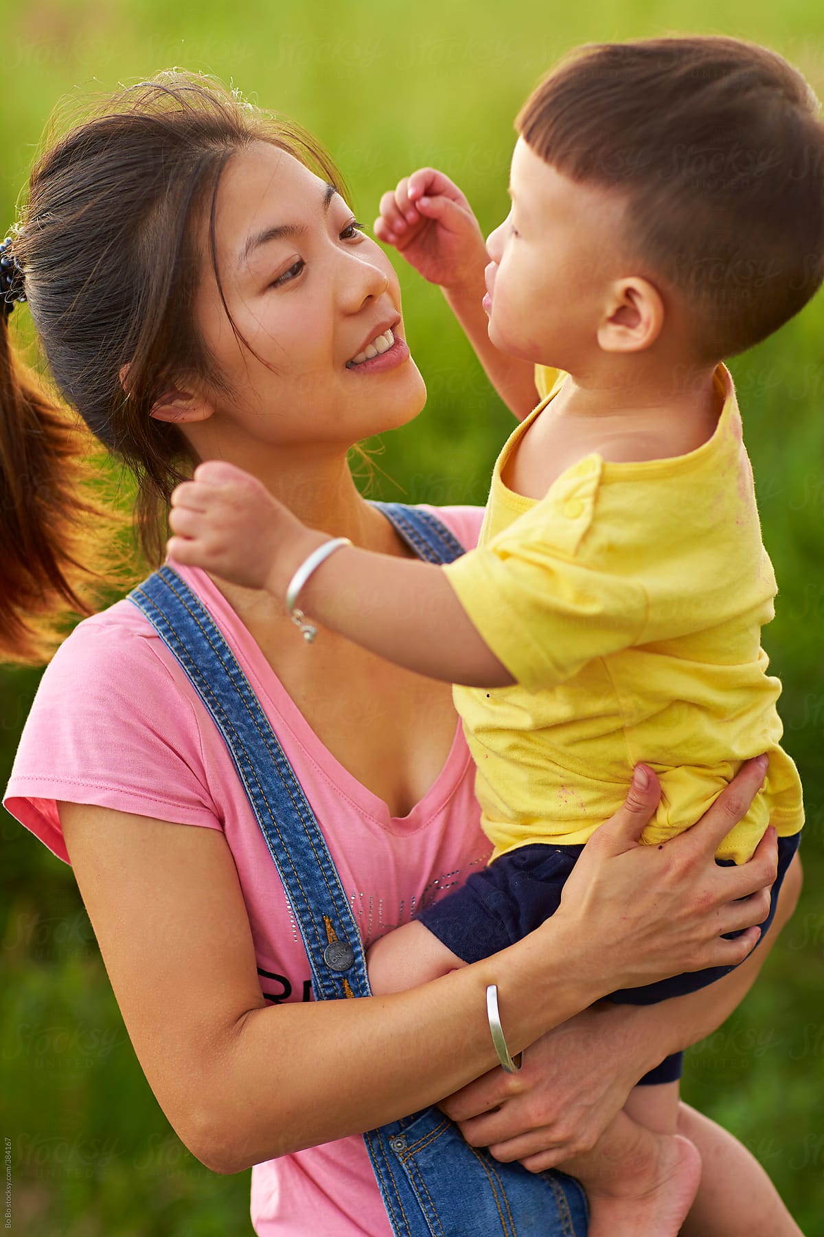 Happy Asian Mother With Her Son Outdoor By Stocksy Contributor Bo Bo
