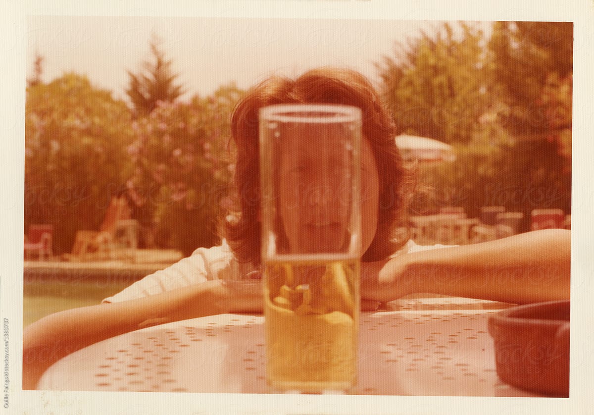 Woman Behind The Glass Of Beer On Table Del Colaborador De Stocksy
