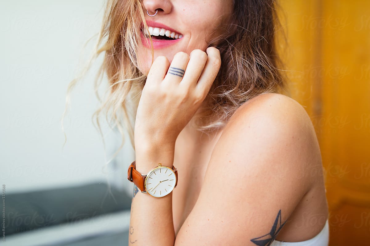 Detail Of Smiling Woman Wearing A Wristwatch by Stocksy Contributor Susana Ramírez Stocksy