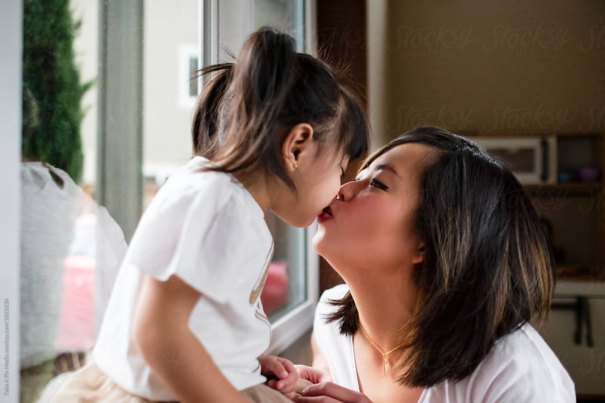 Asian mom teaches daughter to suck
