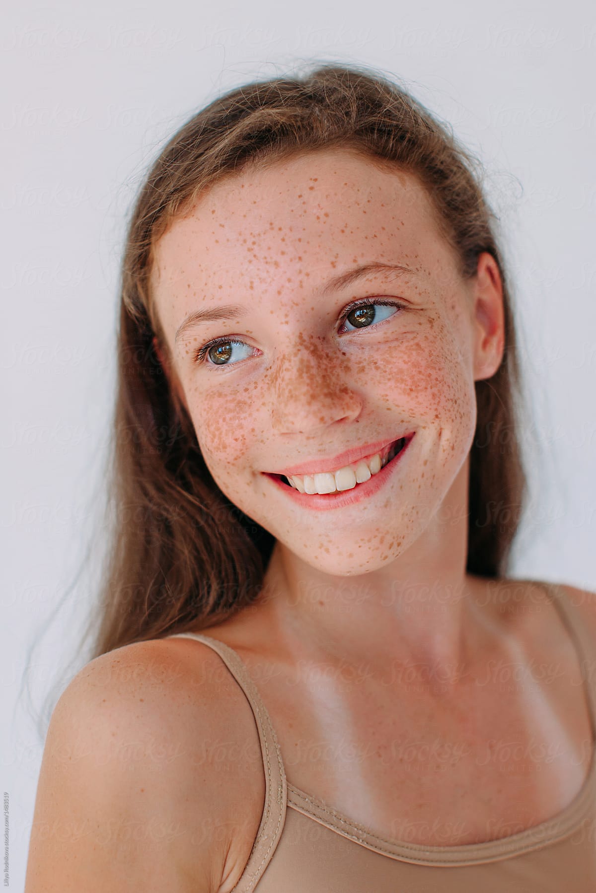 Beauty Portrait Of Attractive Smiling Girl With Freckles And Long Hair