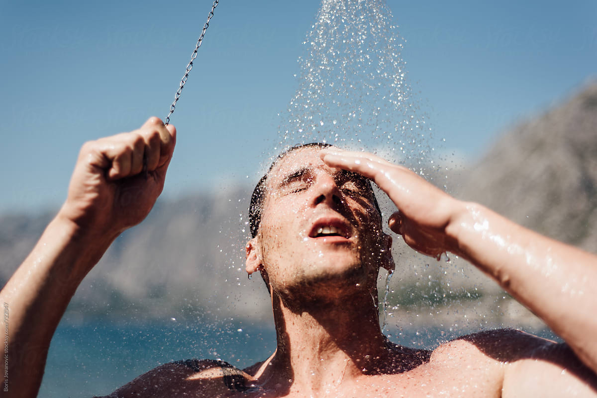 Man Showering At The Beach By Stocksy Contributor Boris Jovanovic