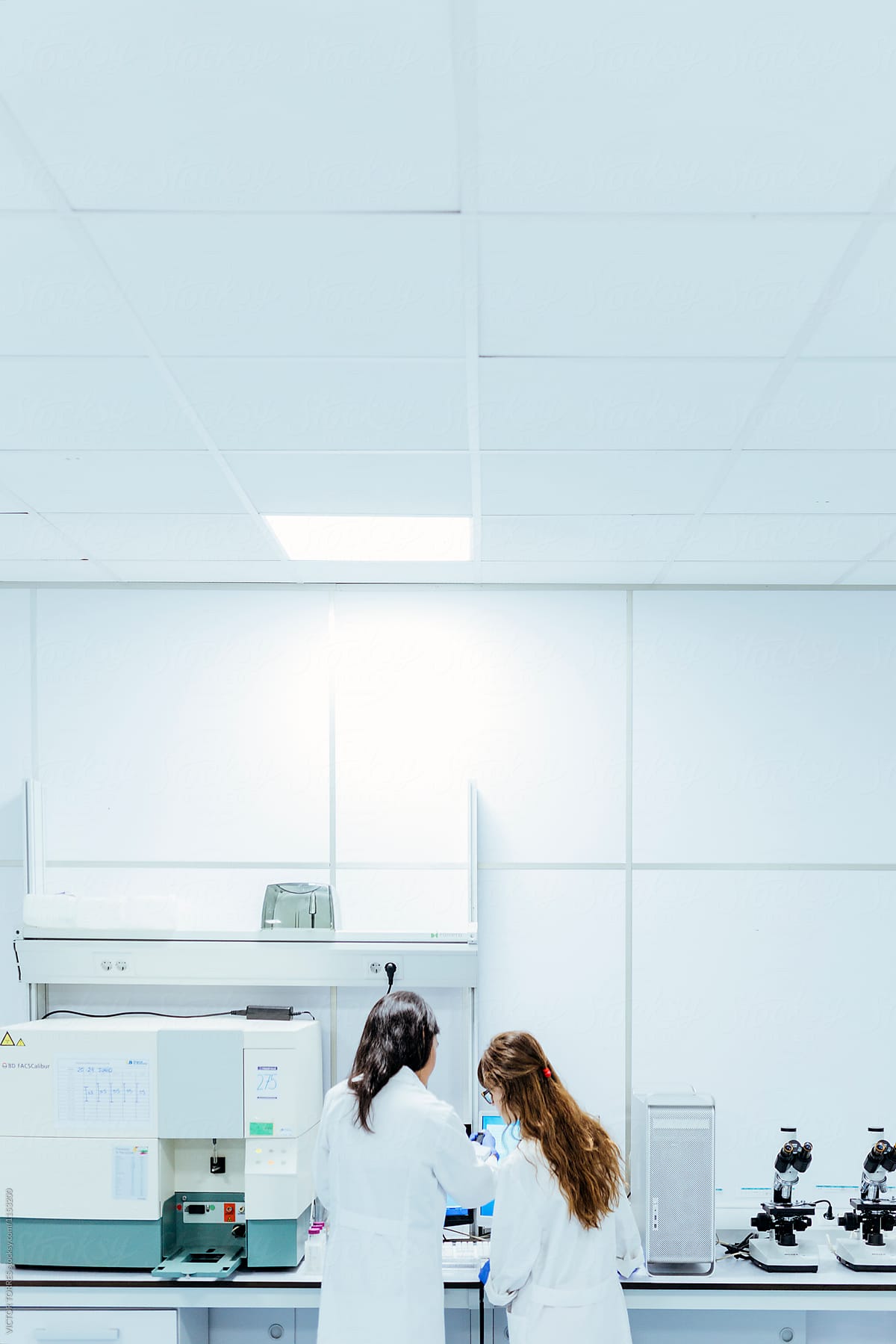Two Young Biologists In Laboratory By Stocksy Contributor Victor