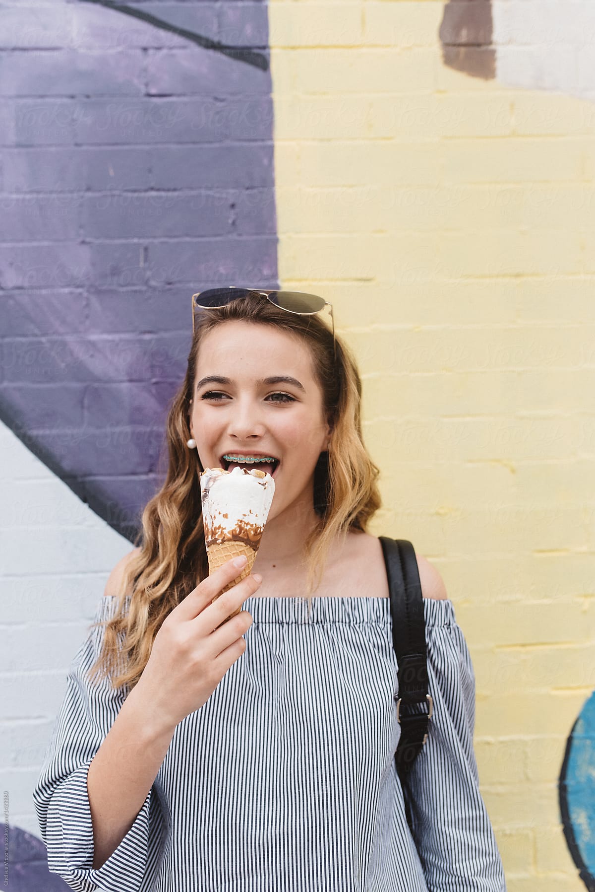 A Teenage Girl Eating Ice Cream In The City By Stocksy Contributor