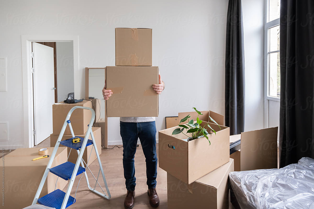 Man Carrying Boxes At New Apartment
