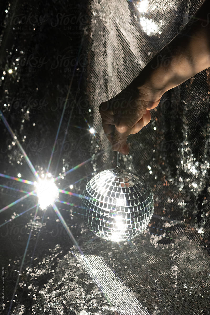 Hand holding disco ball with a star filter