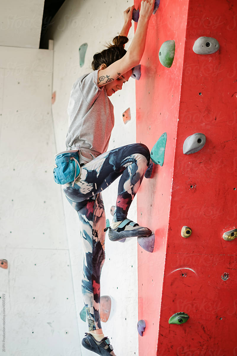 Woman training on indoor climbing wall