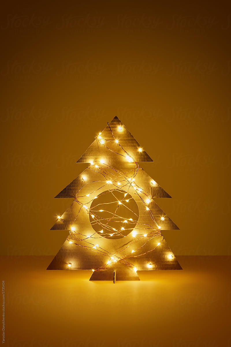 Cardboard Christmas tree with round hole and glowing garlands