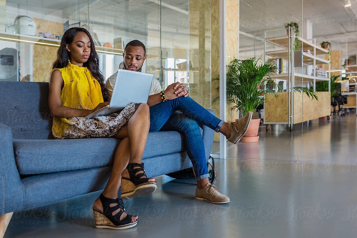 Man and woman on sofa in office