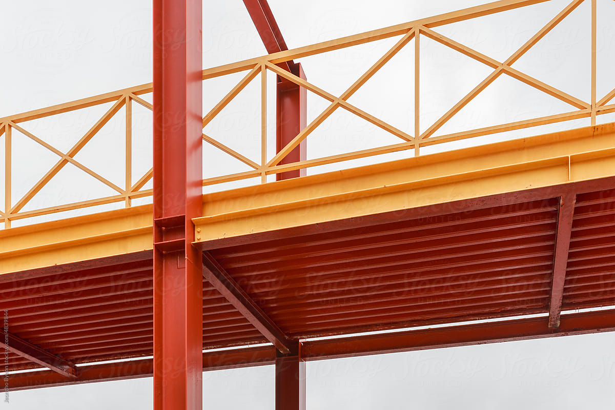 Yellow and red steel bridge close-up.