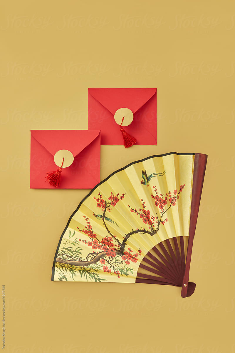 Decorative fan and two red envelopes
