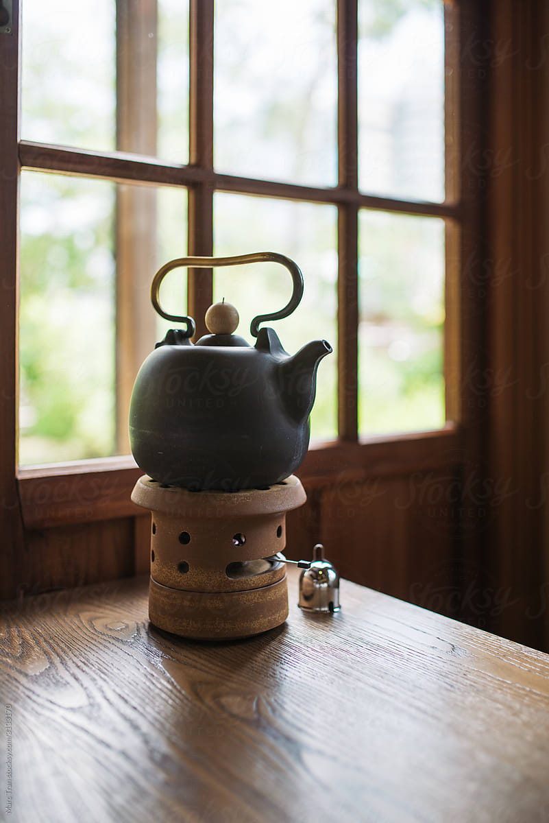 Black ceramic kettles on stove for making tea.