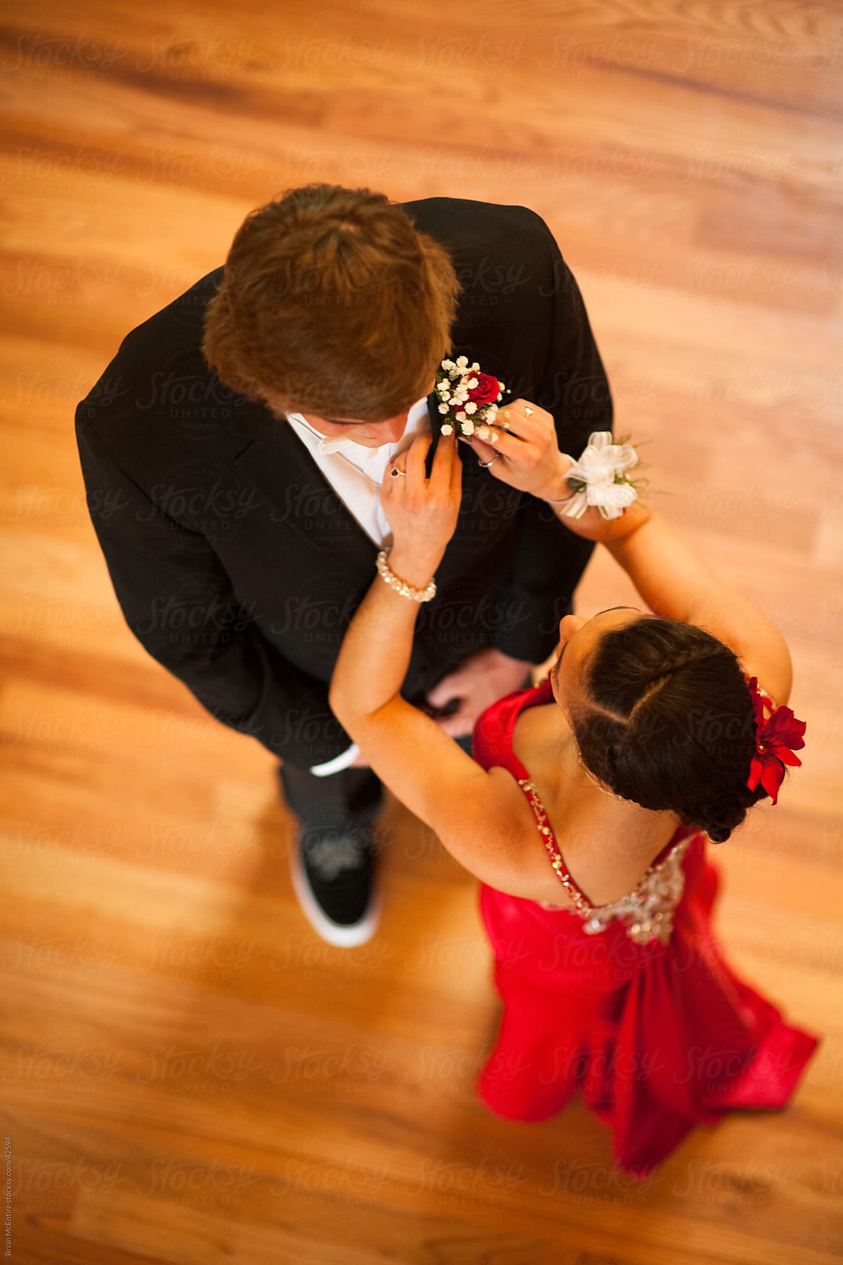 Prom: Young woman pins boutineer on her date