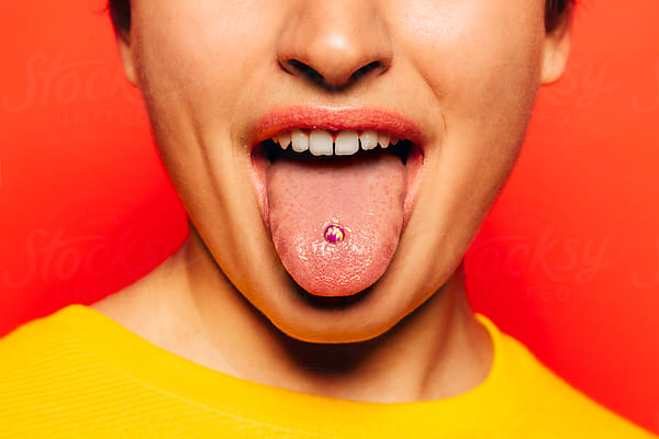 Studio Portrait Of Cute Teen Girls Sticking Out Tongue by Stocksy  Contributor VICTOR TORRES - Stocksy