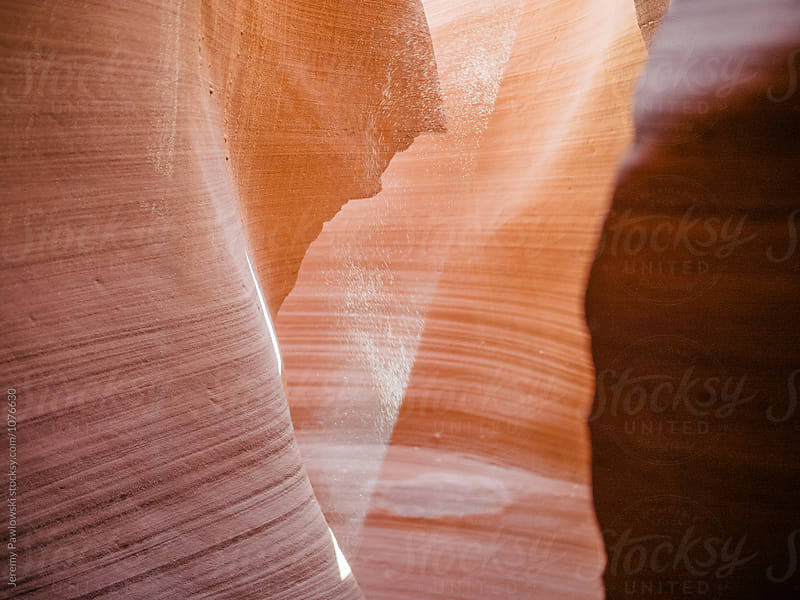 Ray of sunlight shining into Arizona slot canyon with dust