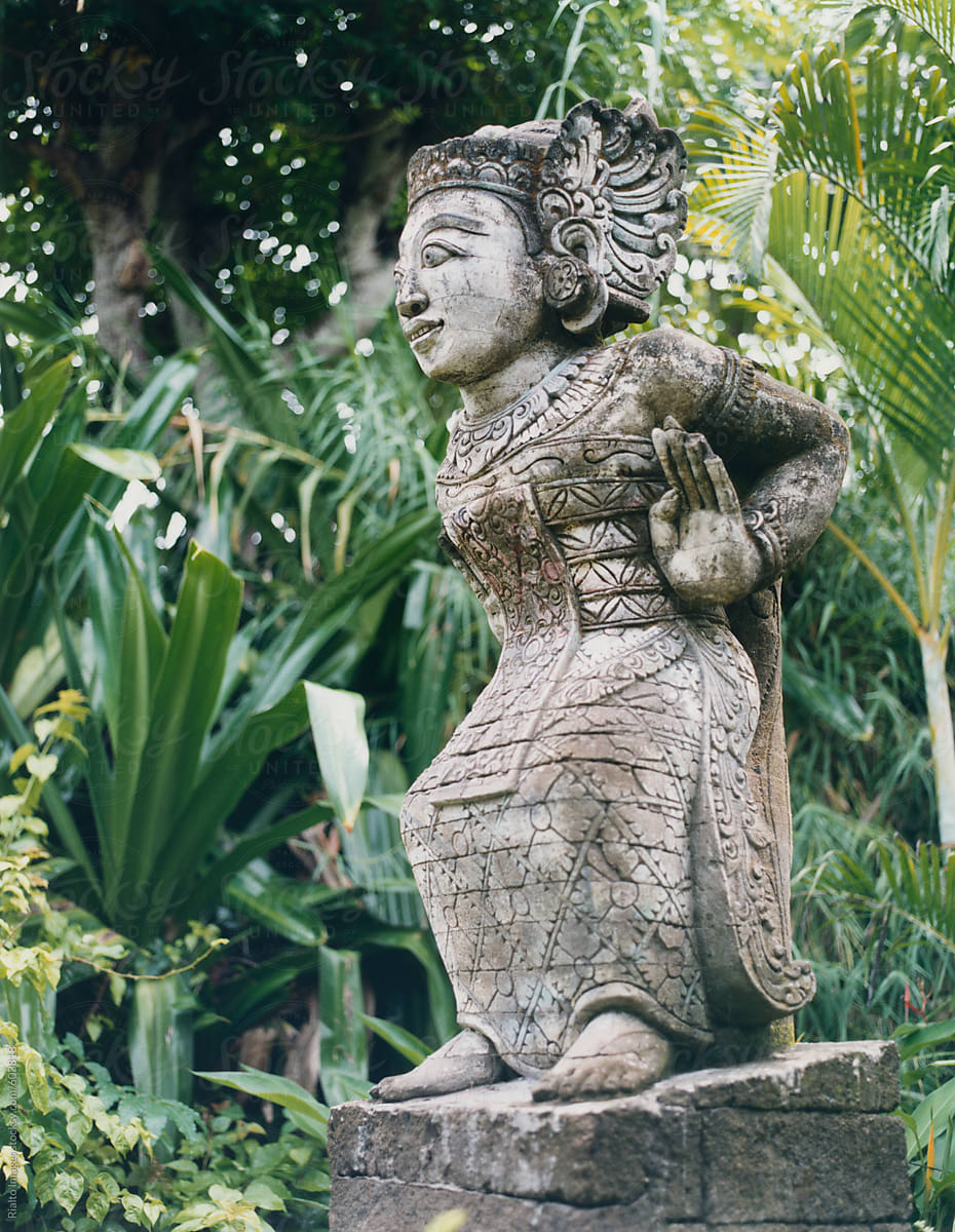Hindu sculpture in lush, tropical garden, Bali