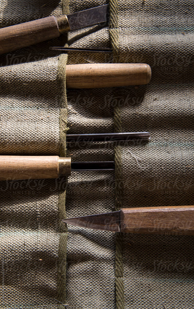Se tof traditional wood carving tools on a rustic fabric background