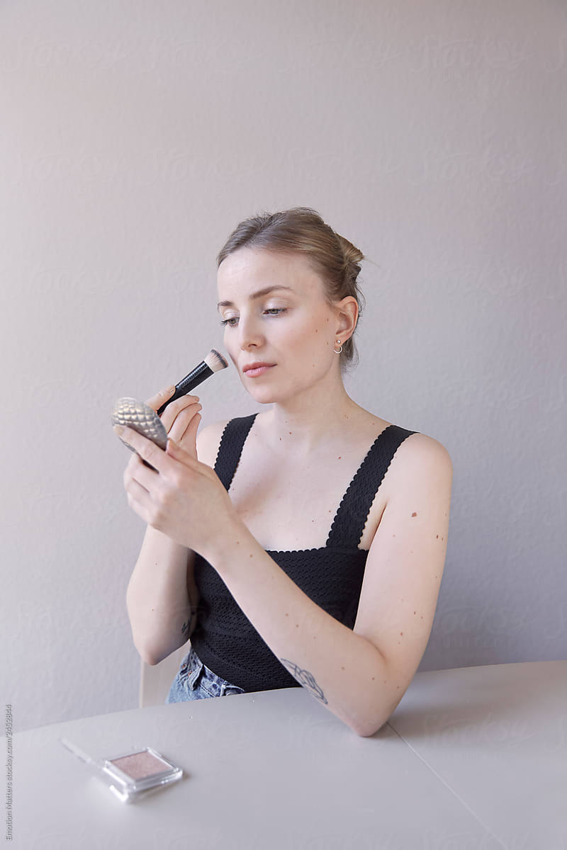 A woman doing her makeup