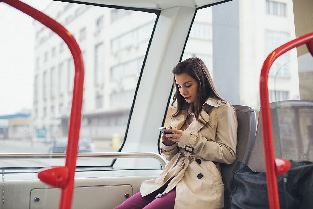 Girl Texting On The Tram By Stocksy Contributor Lumina Stocksy