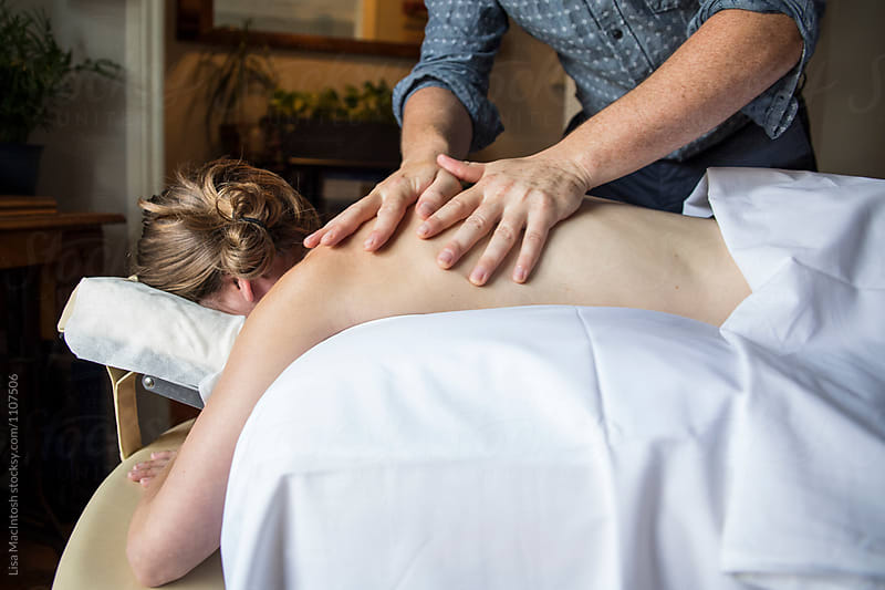 Man preparing woman for acupuncture treatment
