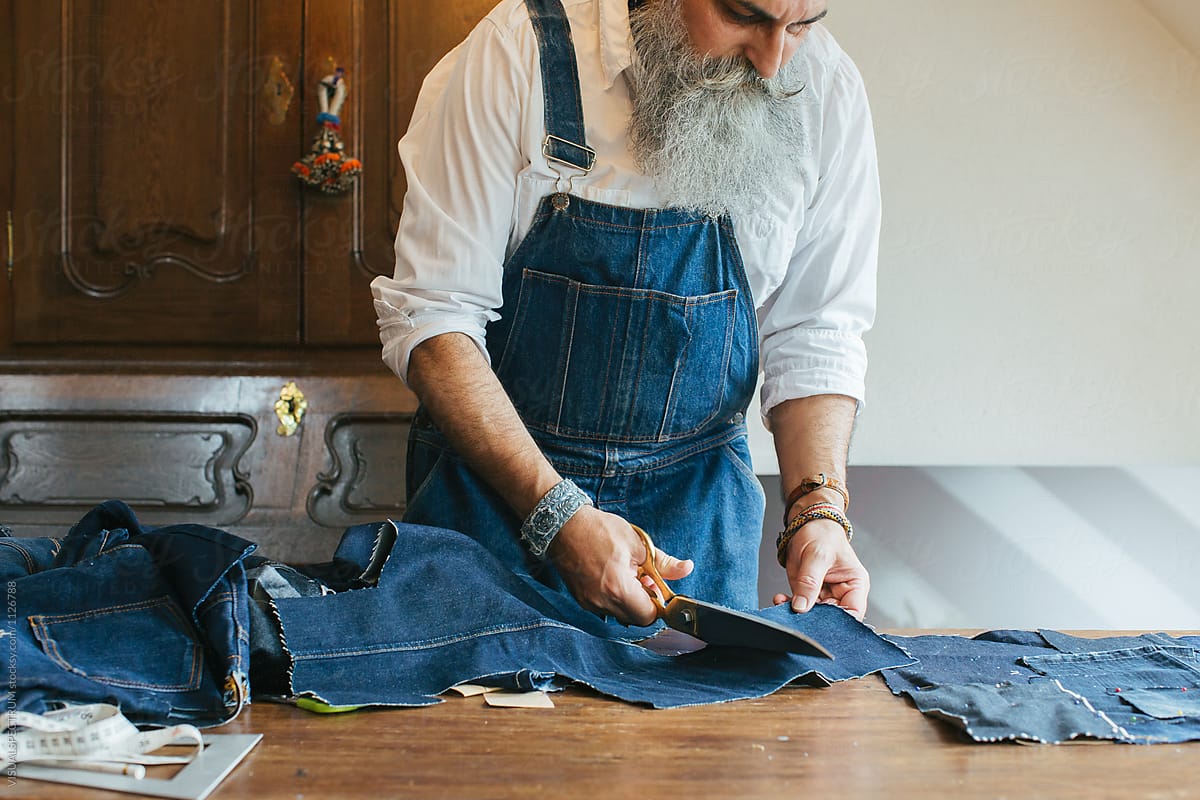 Indoor Portrait of Cool Senior Male Tailor Working on Denim Patchwork