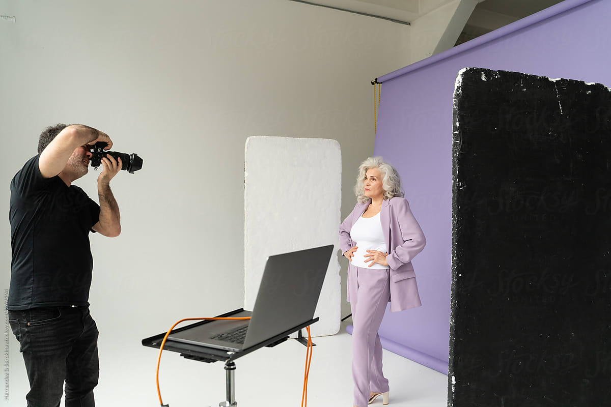 Senior Model Posing For Photographer In Studio