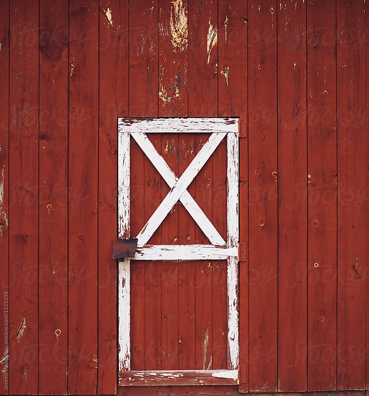 Classic rustic red barn door on New England farm