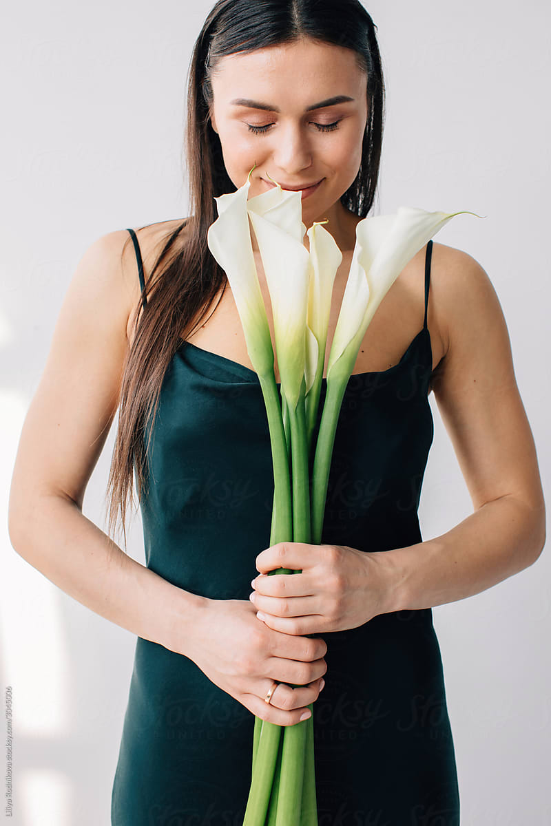 Woman smelling callas and smile