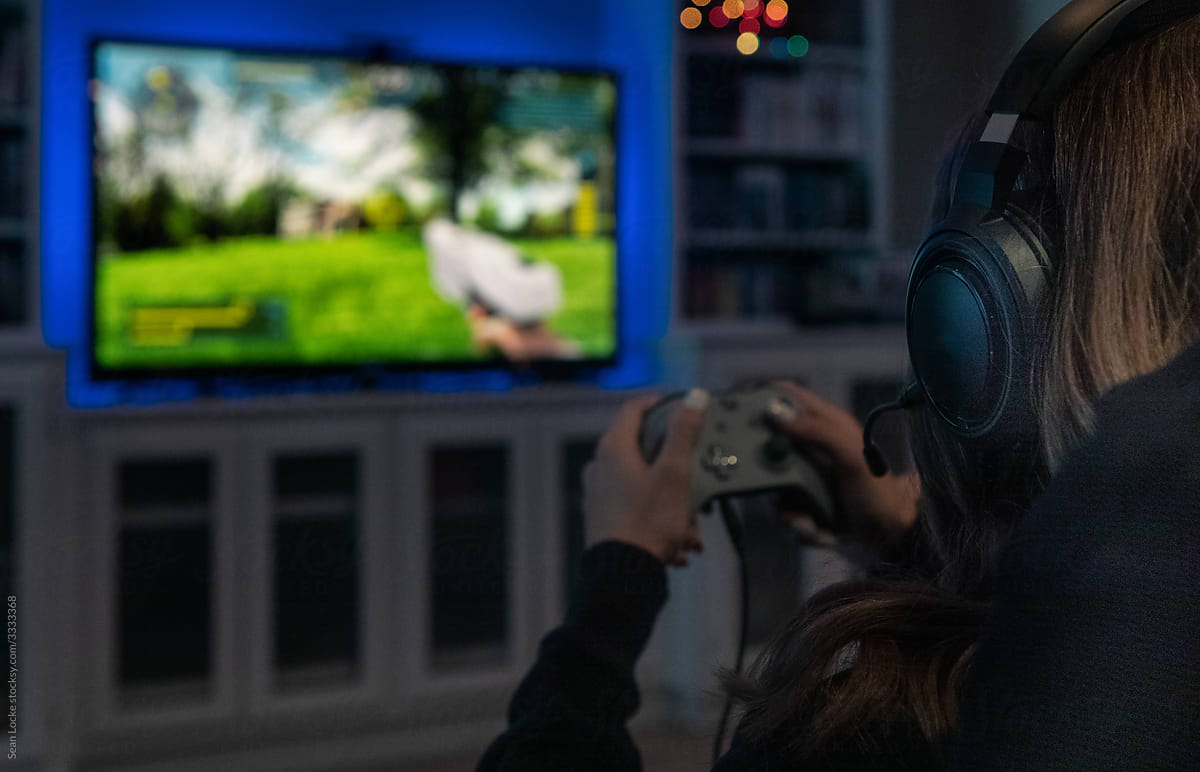 Girl Plays Modern Shooter Video Game On TV