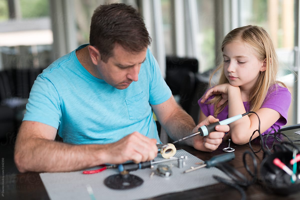 Father Teaching Daughter to Repairing AC Electric Motor