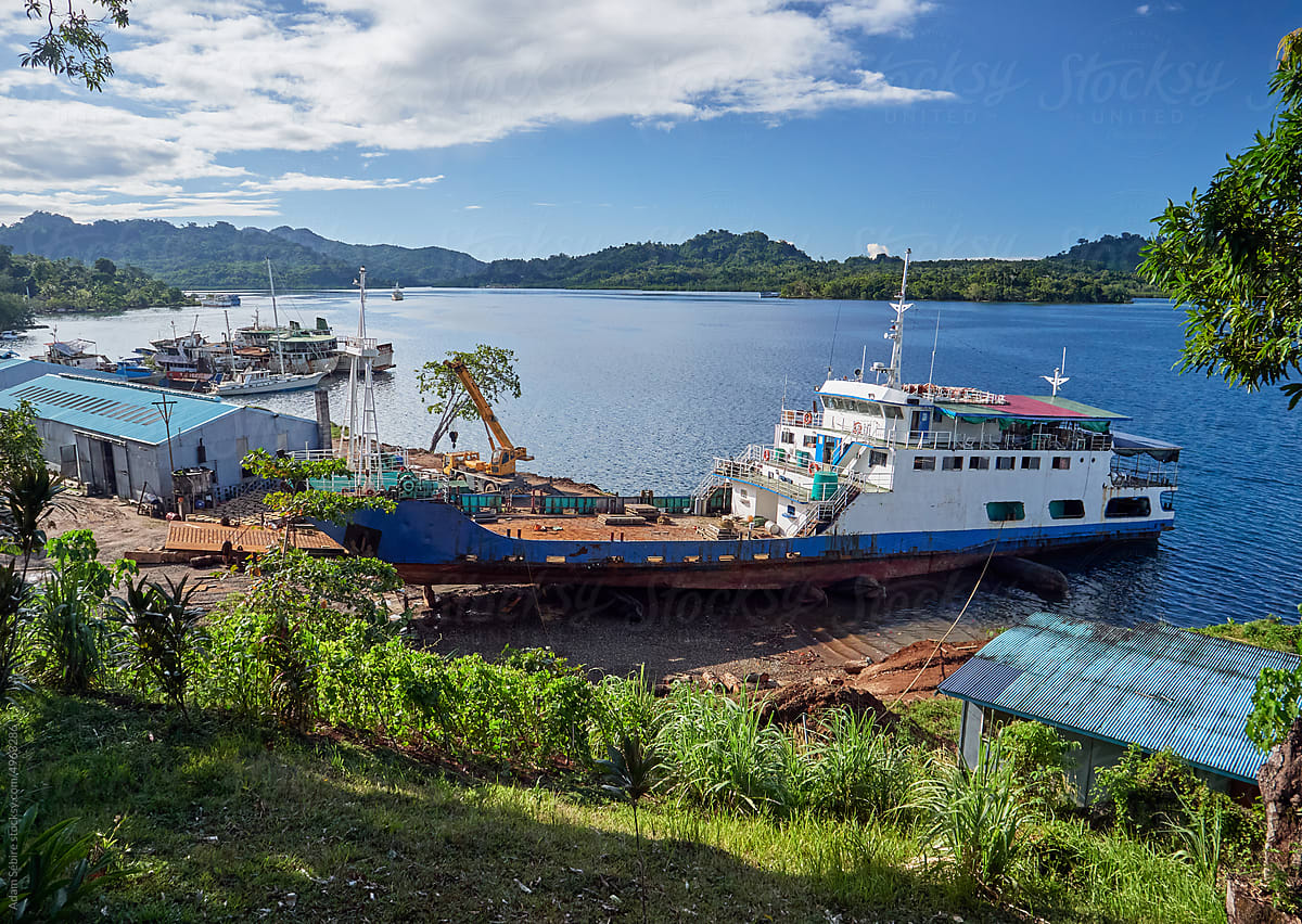 Shipyard dry-dock repairs to inter-island cargo barge, Tulagi harbor