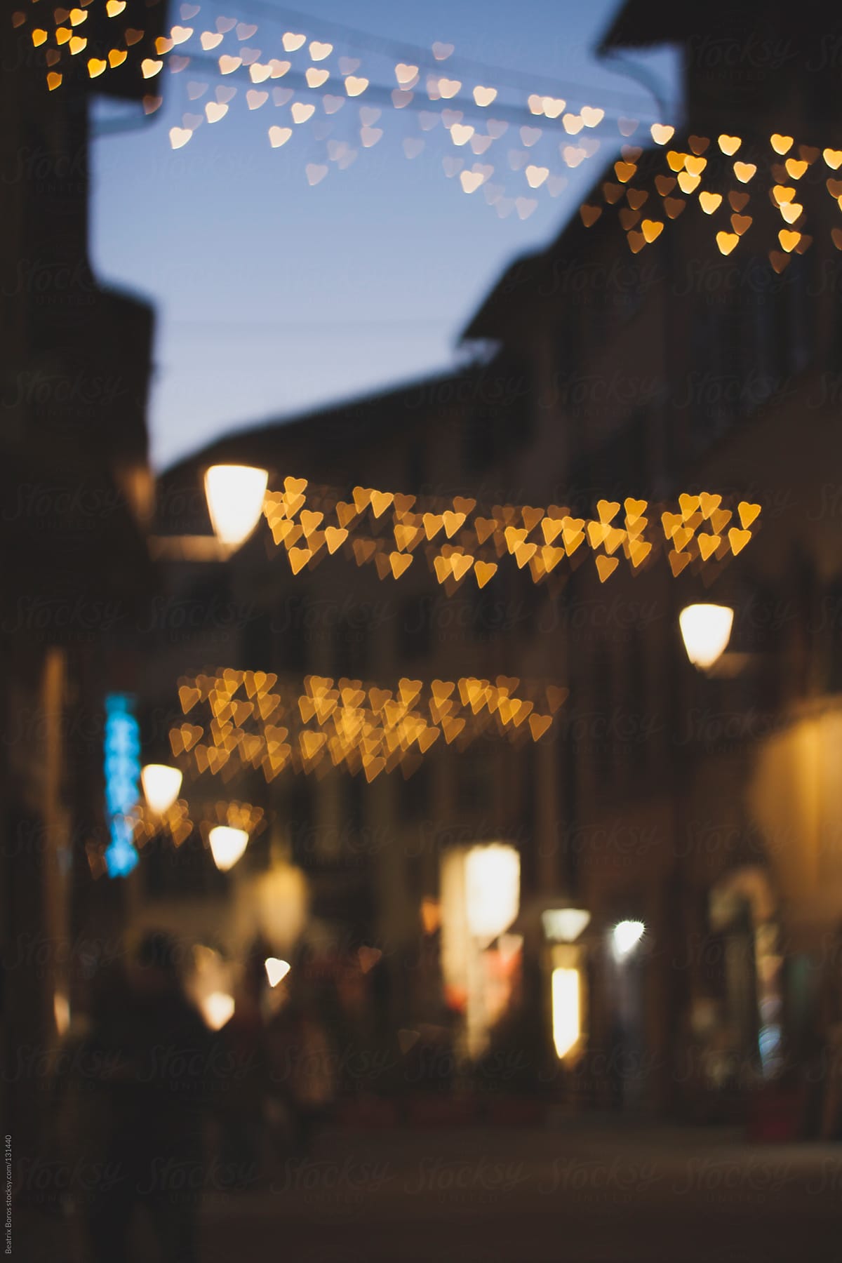 Defocused heart shape Christmas lights in the streets of Italy