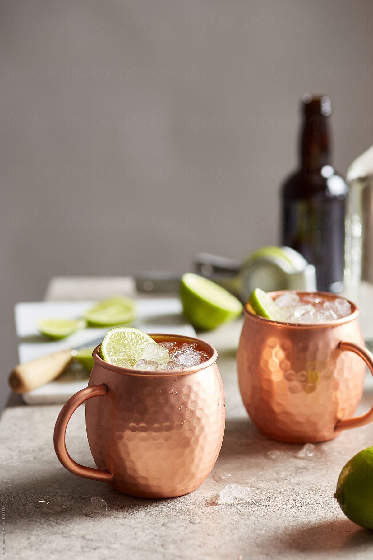 Bronze cups of Moscow mule on table.
