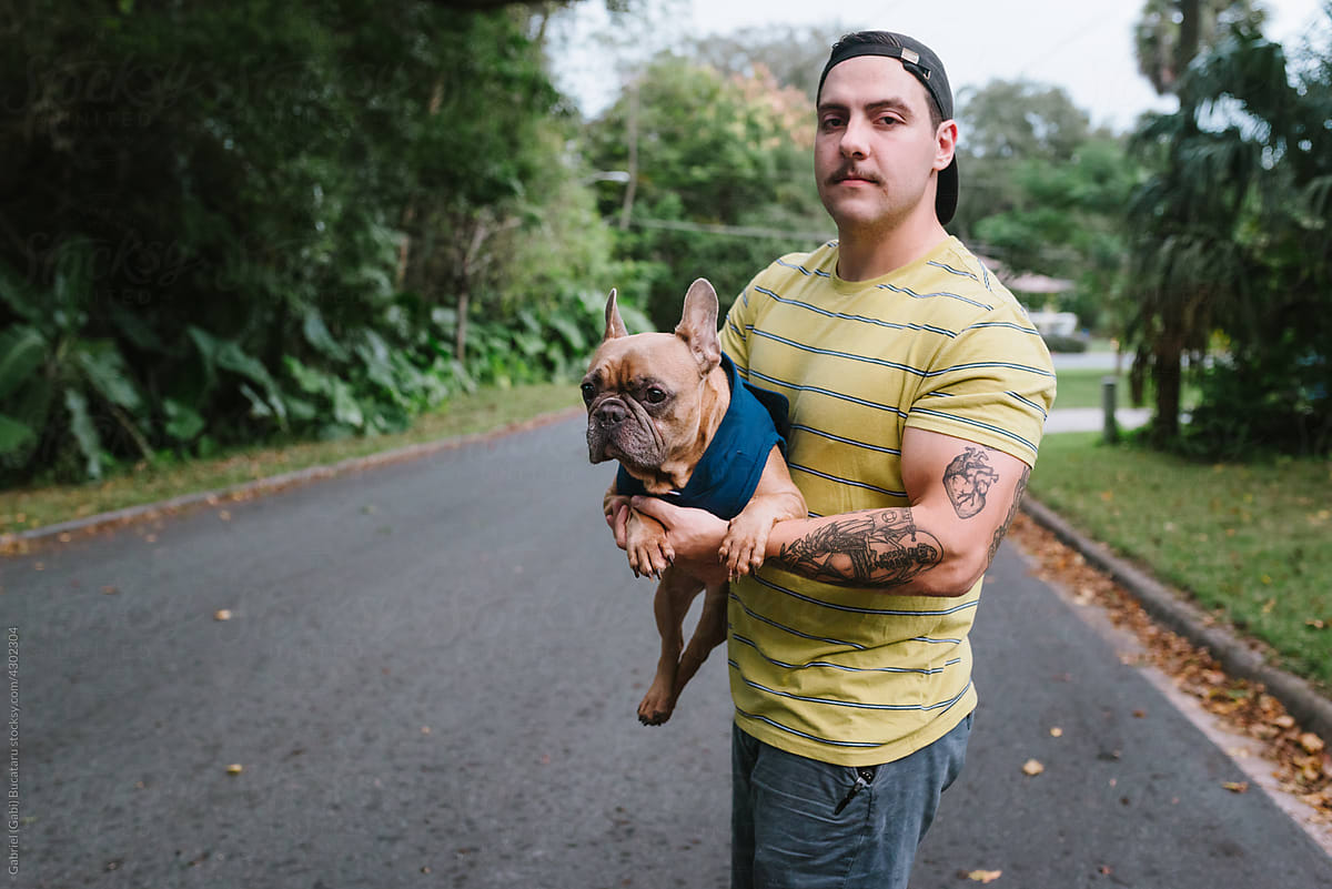 Tattooed man with French bulldog