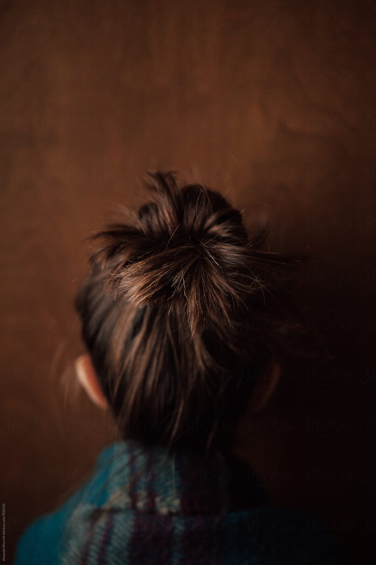 Back view of little girl with hair in a messy bun