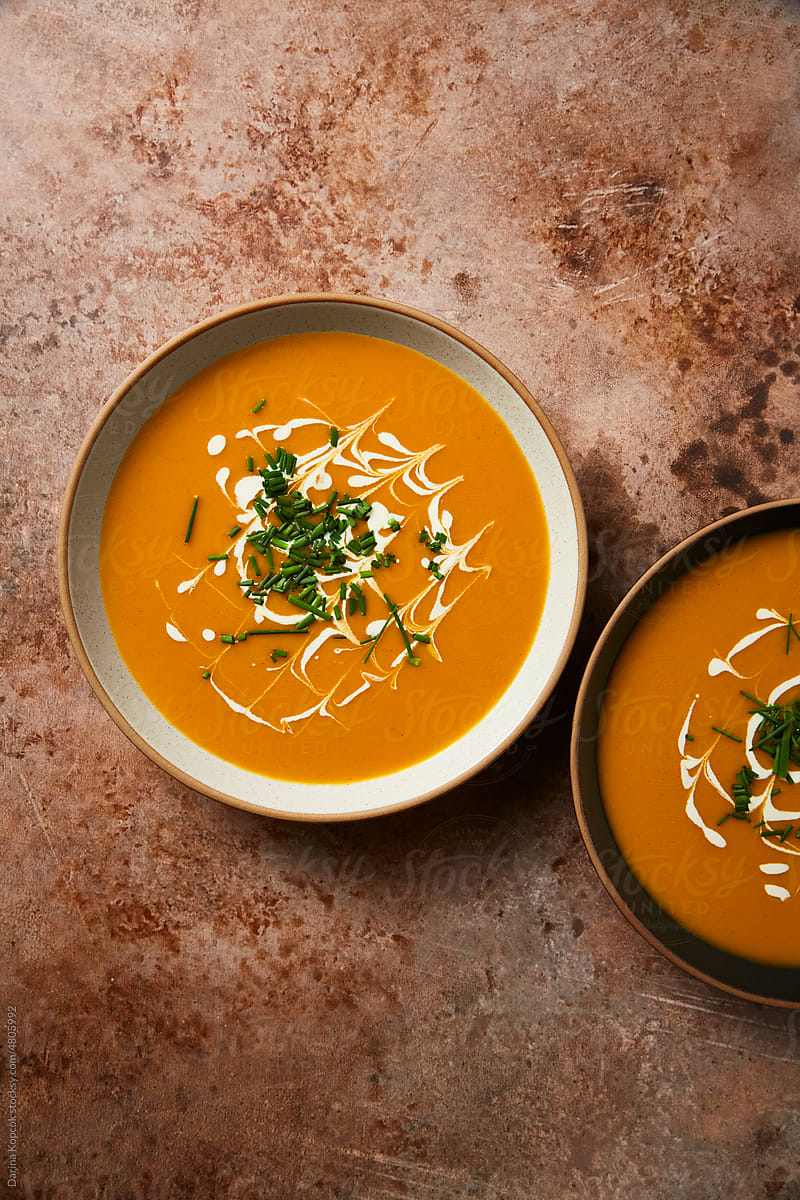 Two Ceramic Bowls of Butternut Squash Soup