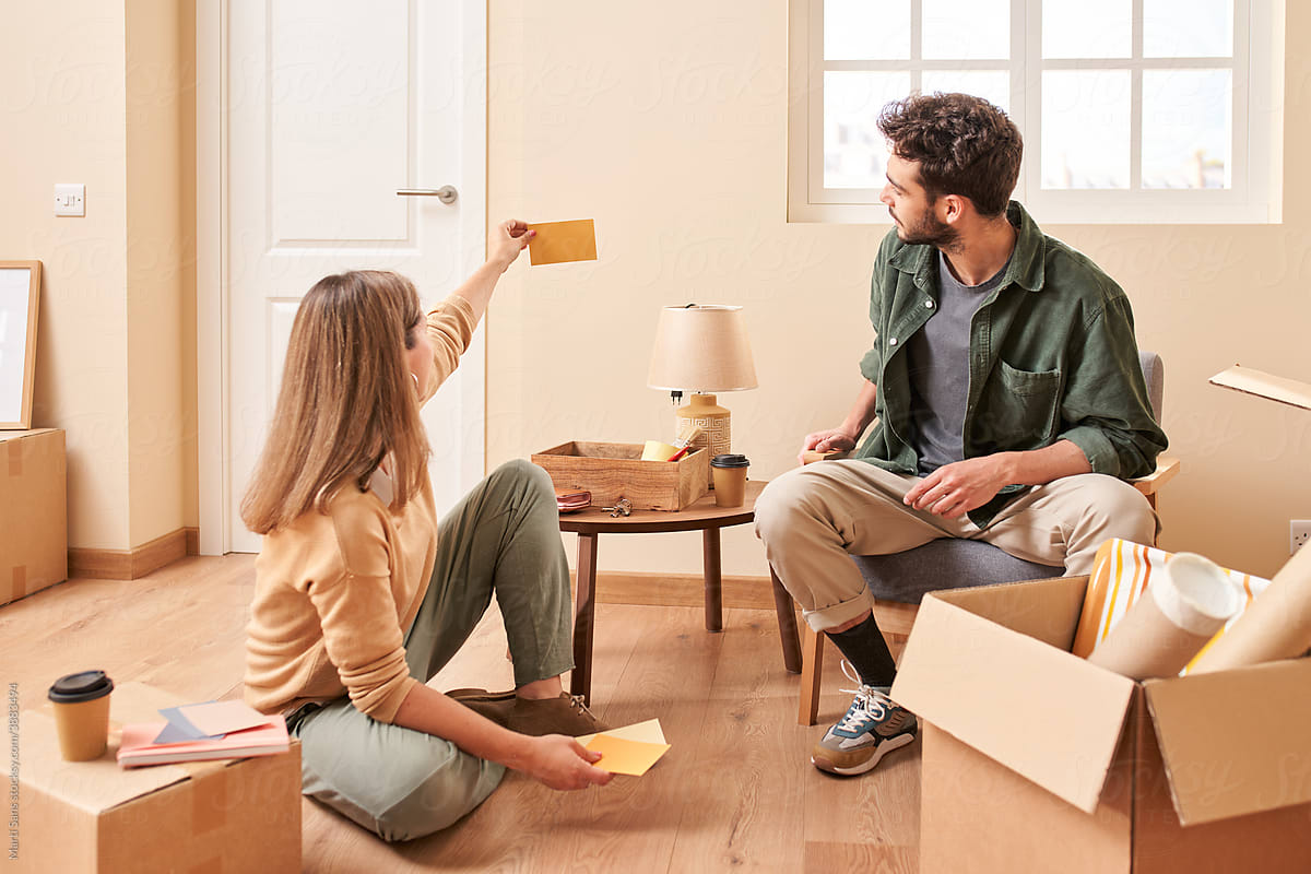 Young couple choosing wall color in new apartment
