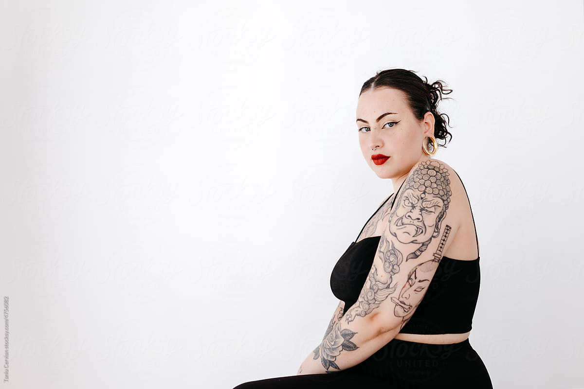 Tattooed woman in black outfit