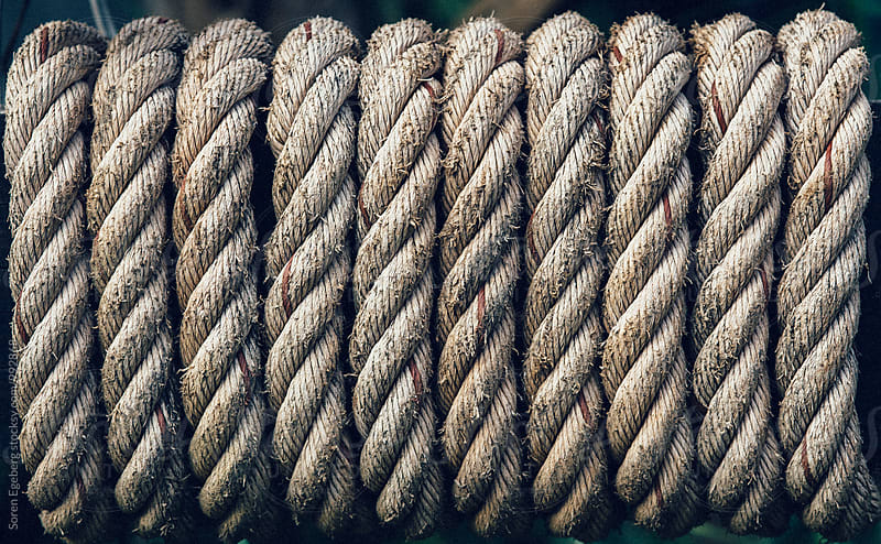 Old rope tied tight around a plank