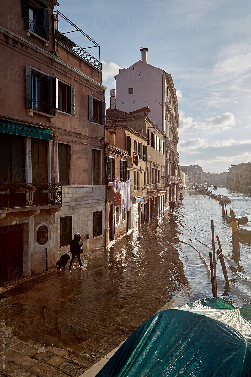 Acqua alta king tide overflows canal banks in Venice