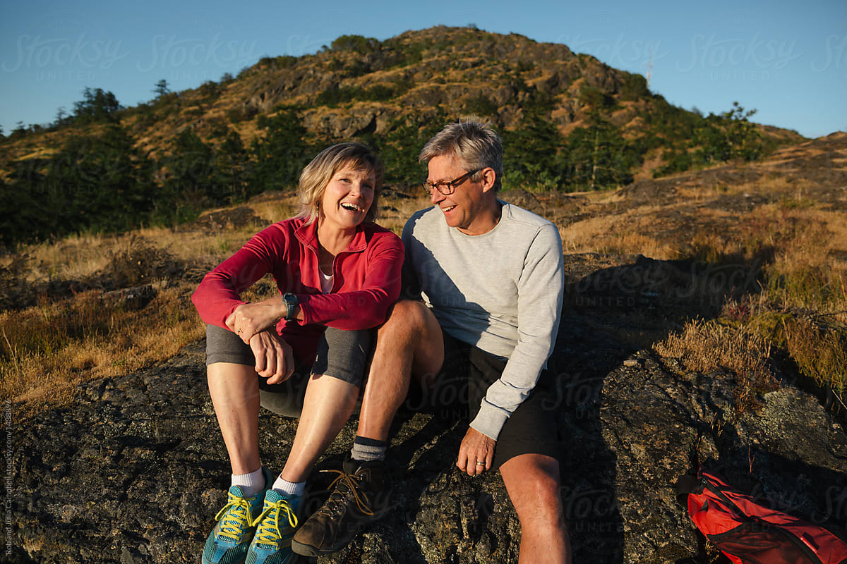 Fit, active middle age couple hiking together at sunset