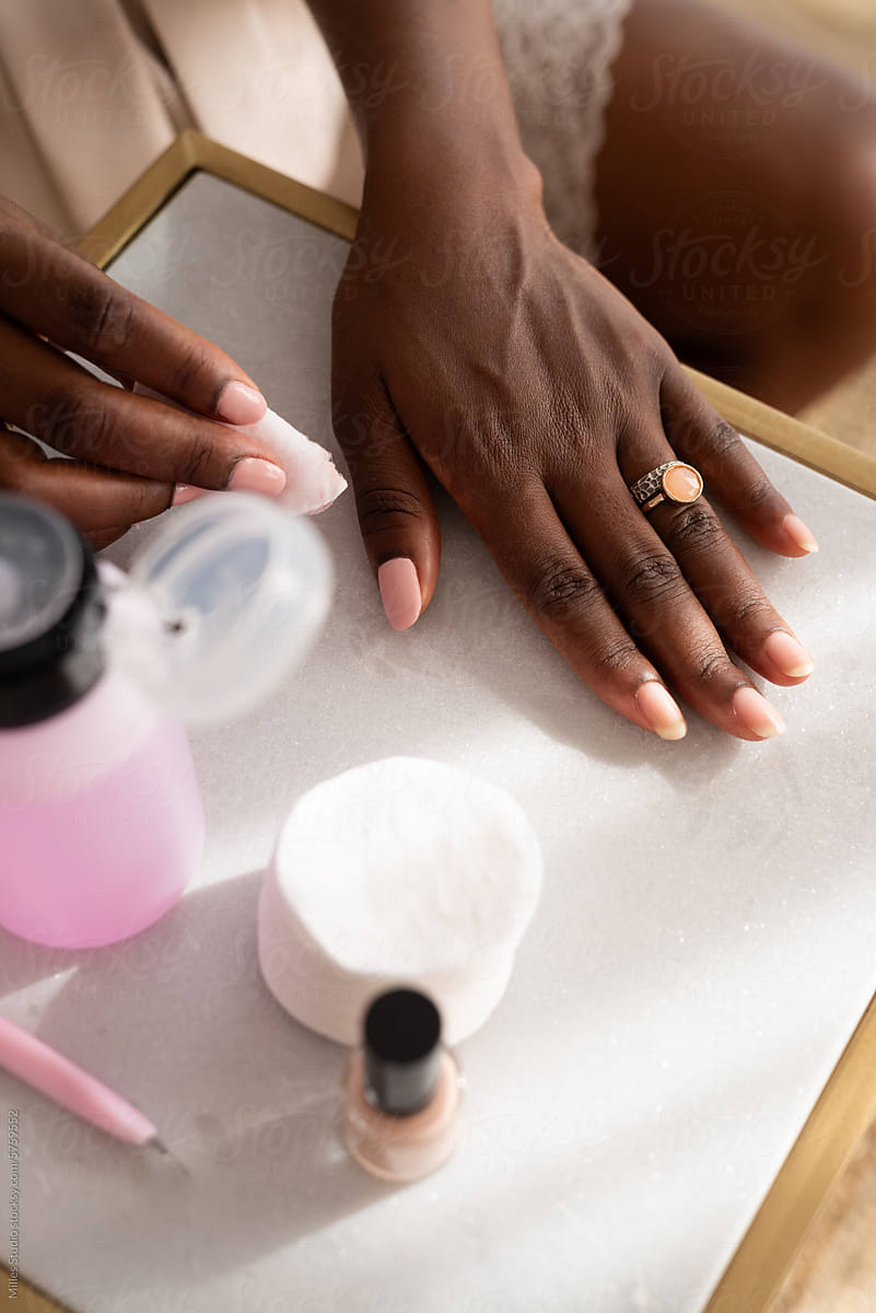 Using cotton pads and nail polish remover