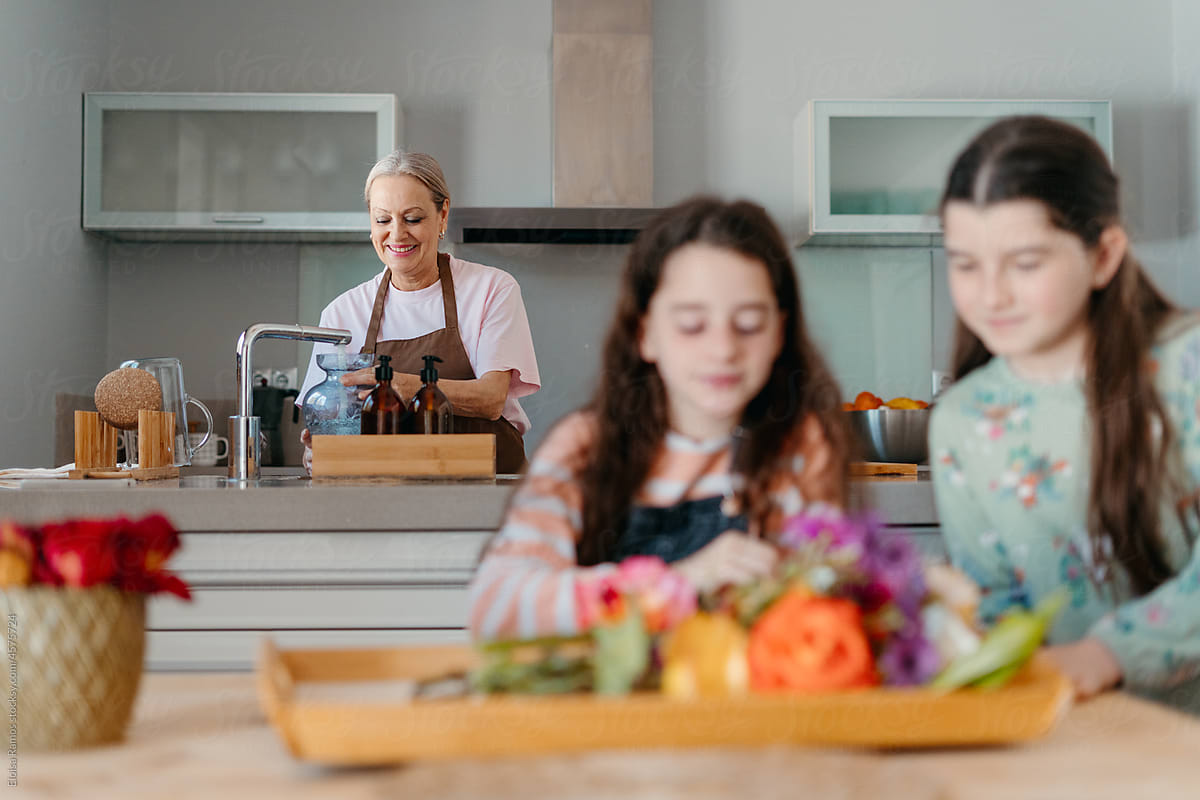 Kids with colored roses in kitchen