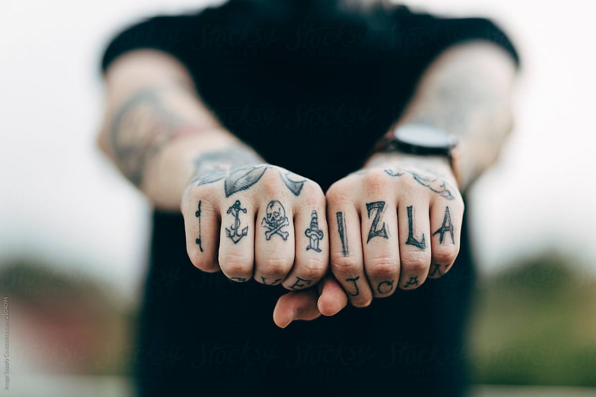 White male with tattooed hands.