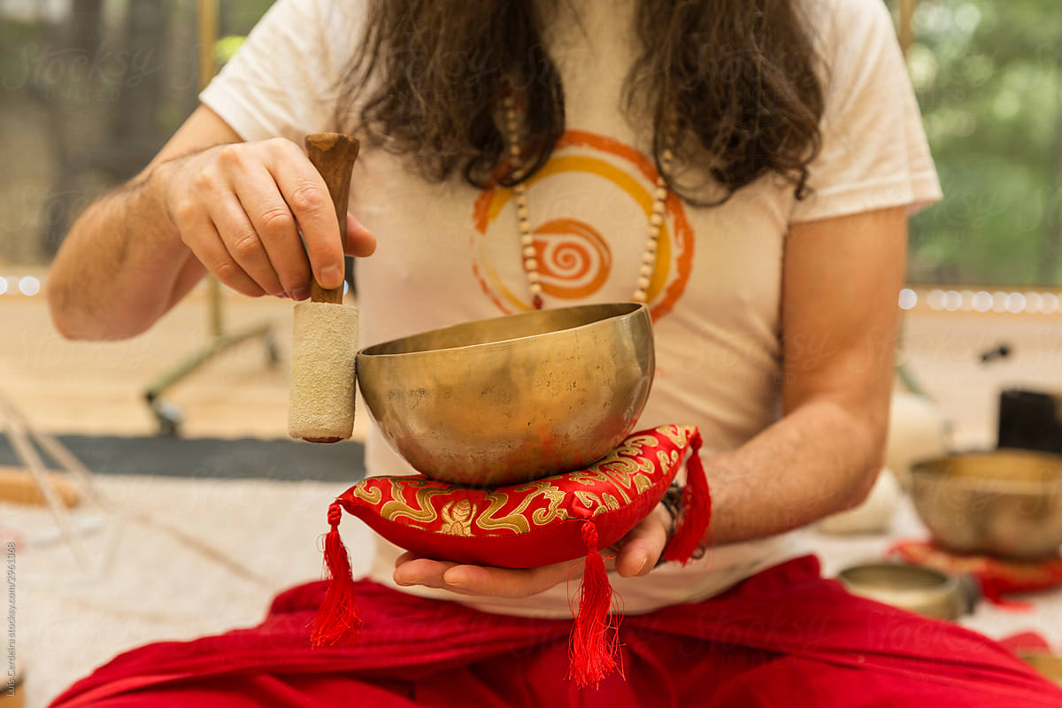 Therapist performing music therapy with a singing bowl