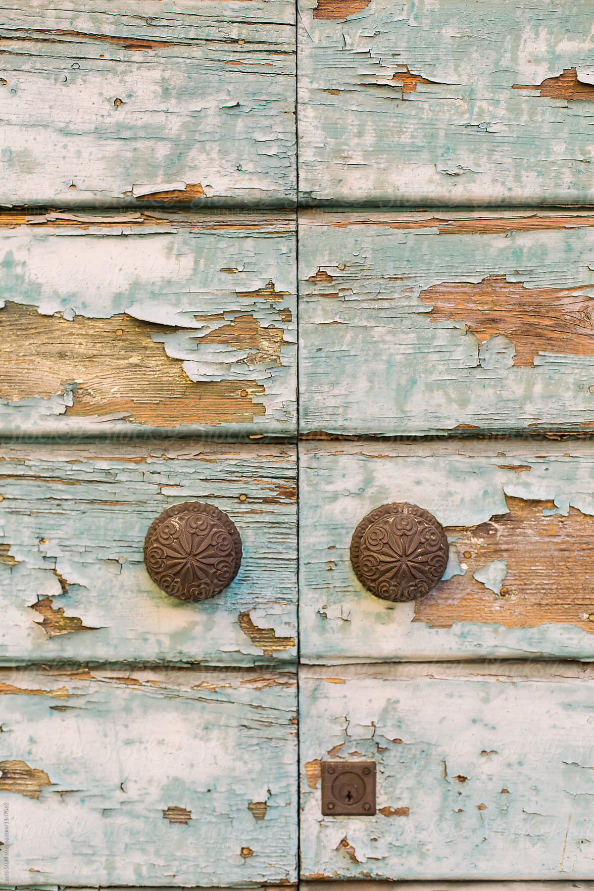 Couple of old brass door knobs on old main door in Italy