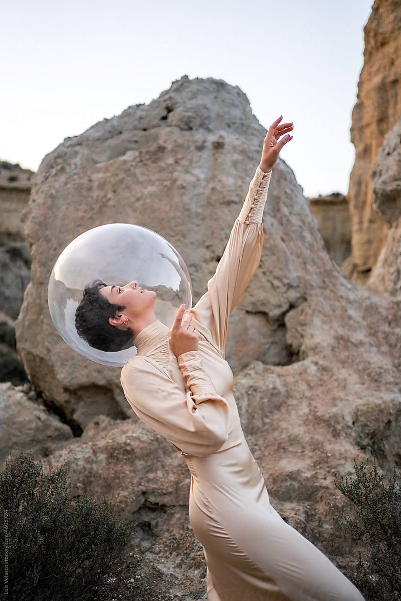 Portrait Of A Dancer With Dress And Bubble Helmet In The Desert.