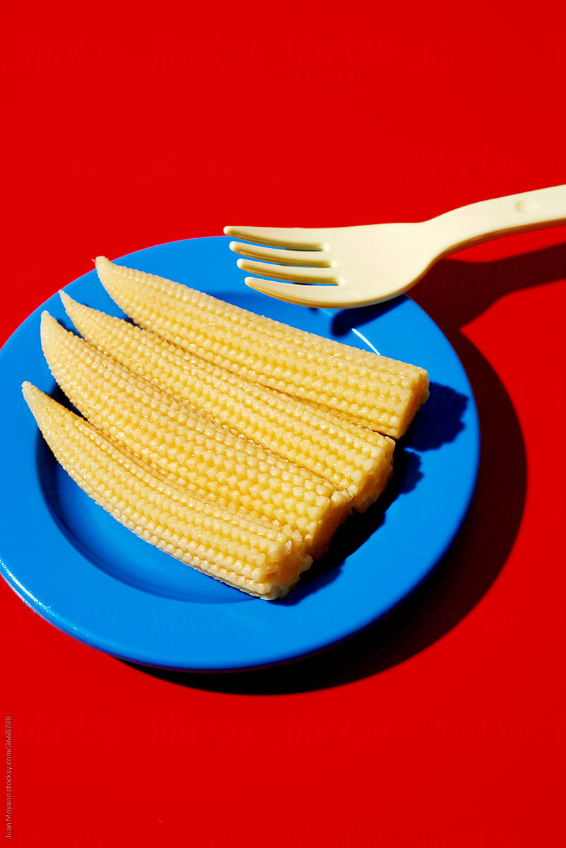 baby corns and fork in a plate